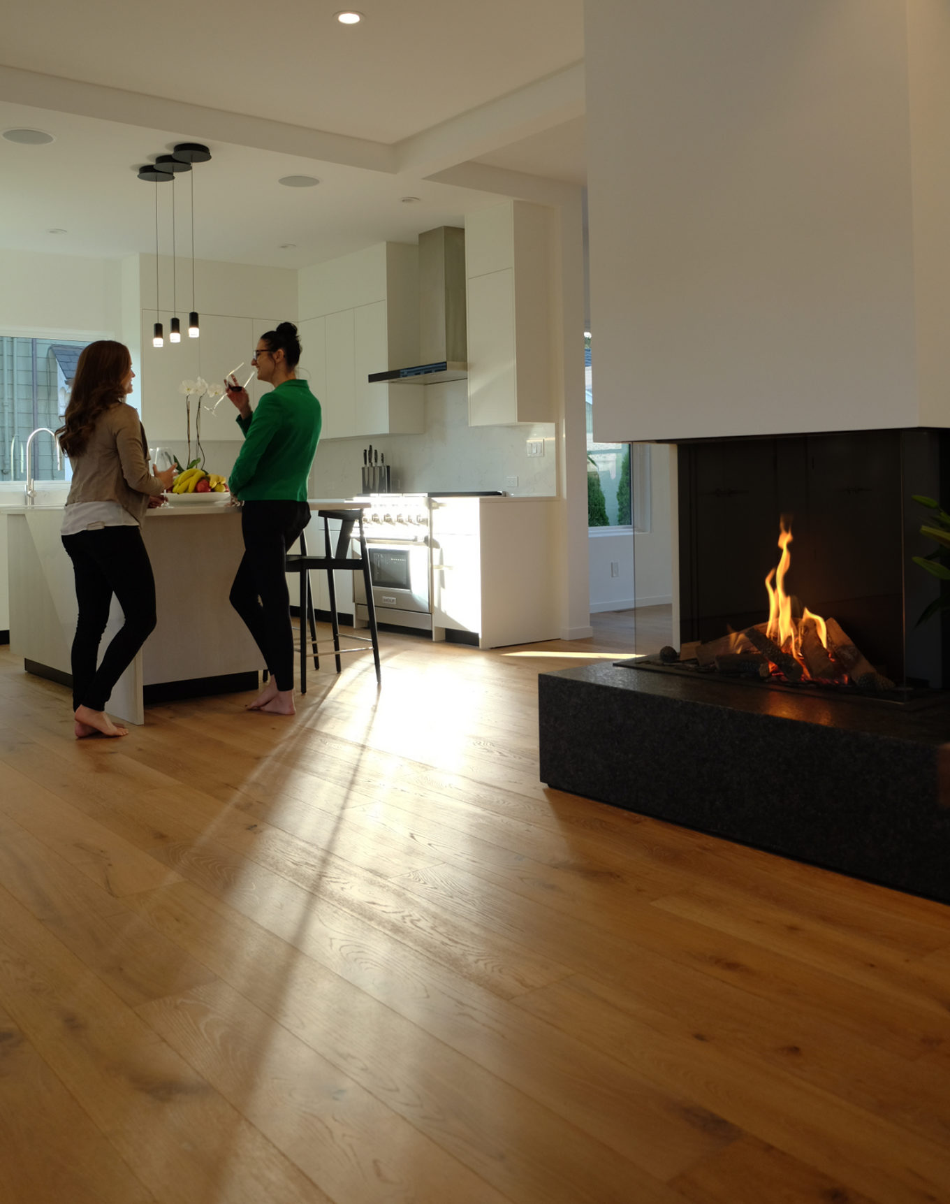modern three sided gas fireplace in a minimalist interior